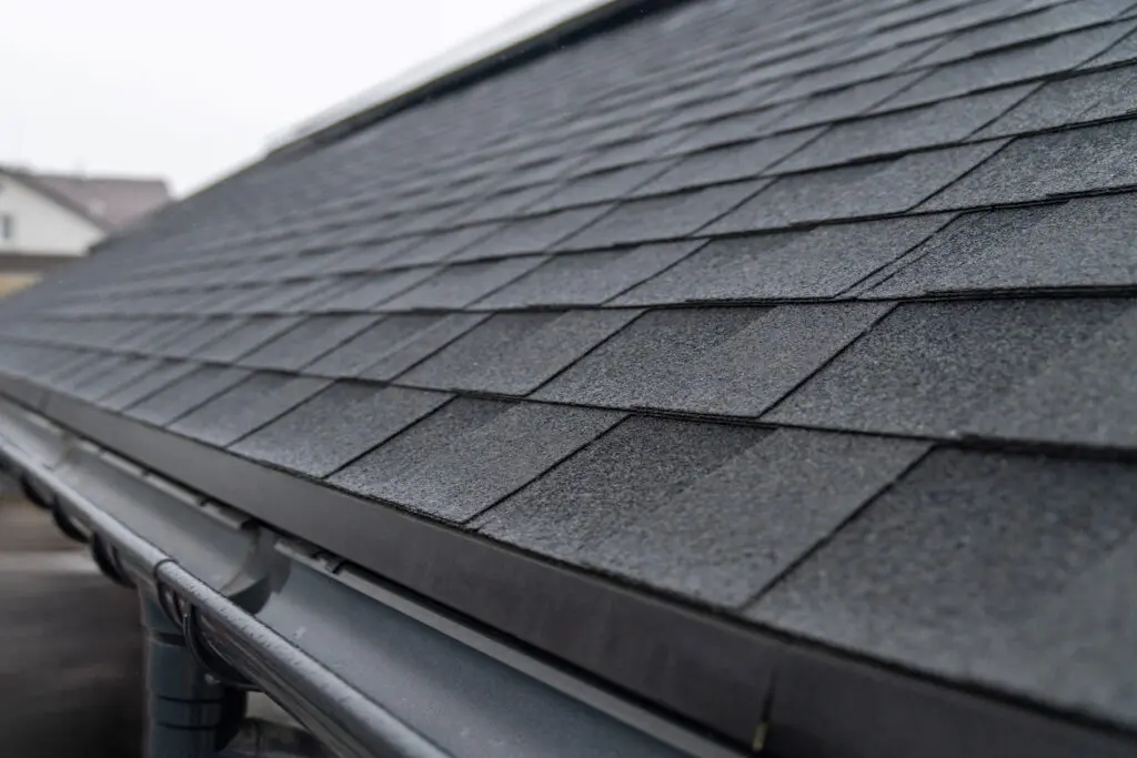 close up of gutters on a home with a black shingle roof in south florida