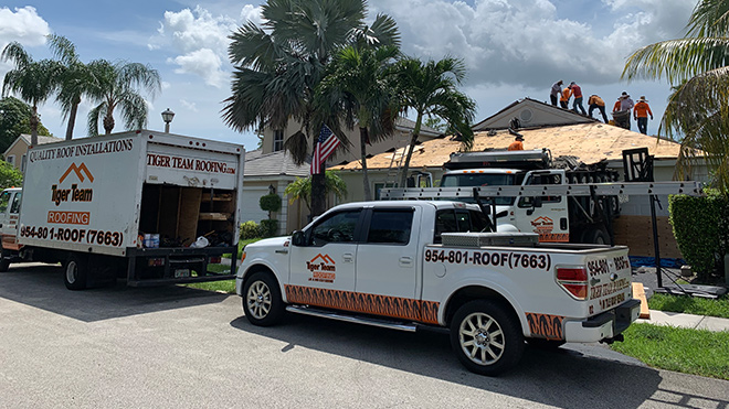 Tiger Team Roofing workers working on a new roof in Coral Springs, FL