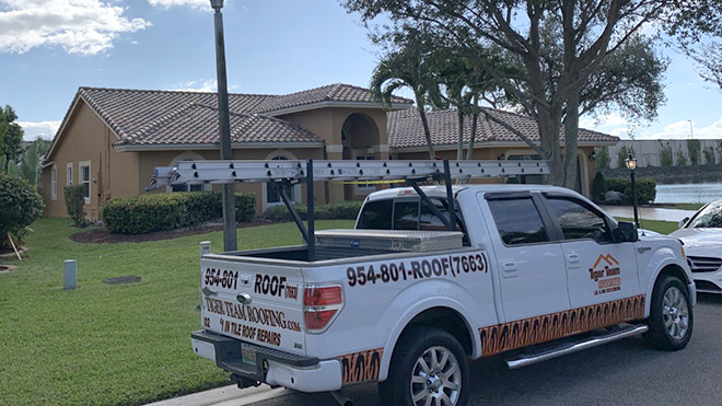 Eagle Capistrano roof in Parkland Florida with a Tiger Team Roofing truck parked in front of the home