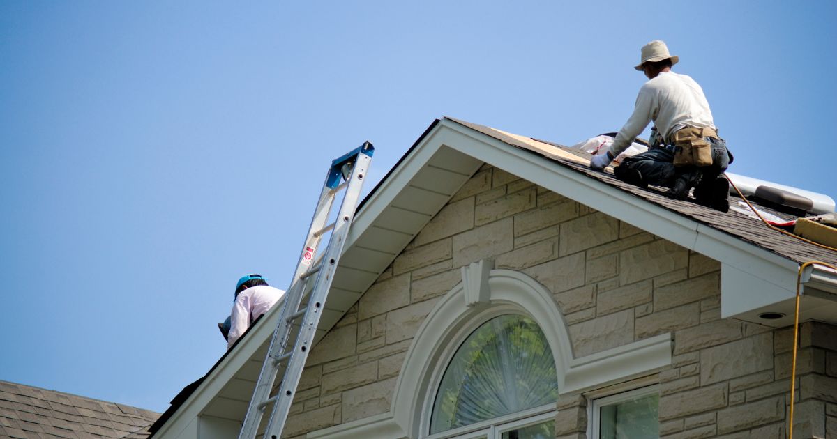 Roofing company workers finishing a job