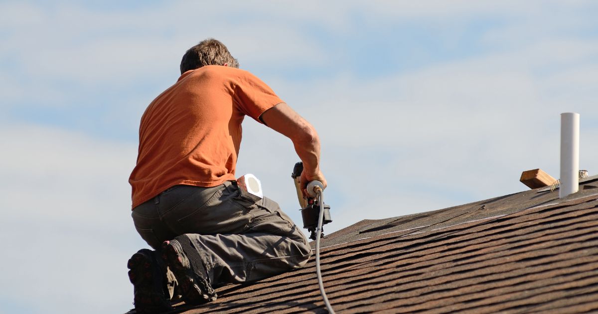 roofing contractor fixing roof