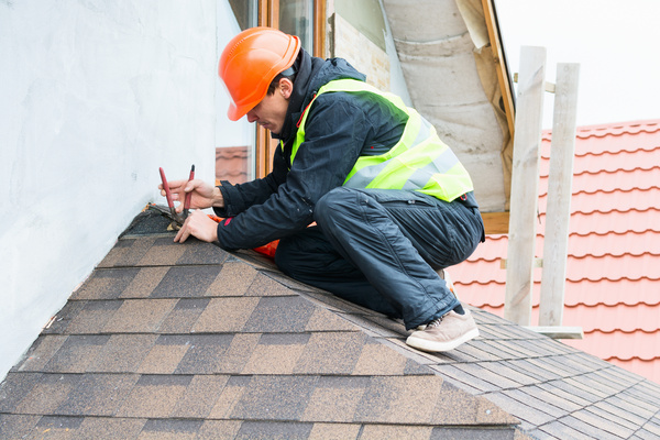 roof repair worker on a roof working