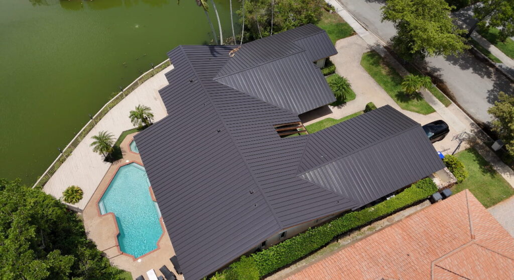 Aerial view of a waterfront home with a black standing seam metal roof in Fort Lauderdale, Florida