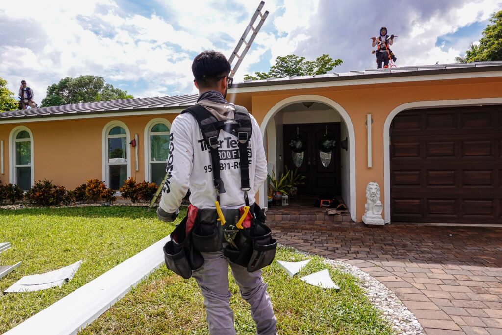 Tiger Team Roofing crew installing a metal roof on a South Florida home.