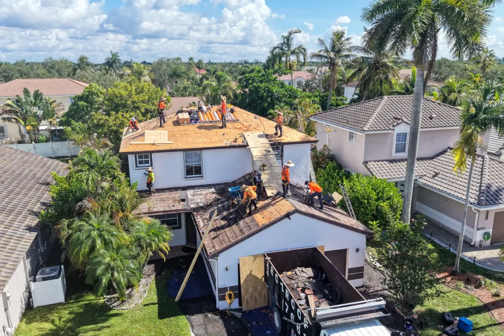 Aerial view of a Tiger Team Roofing crew replacing a roof in a South Florida neighborhood