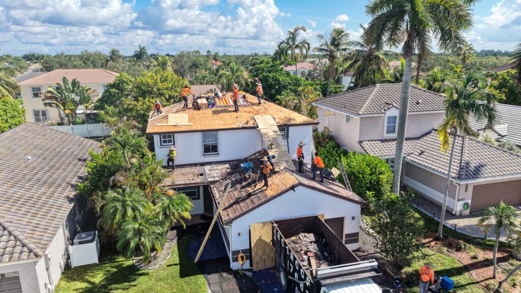 Roofing crew removing old roofing materials during a residential roof replacement.
